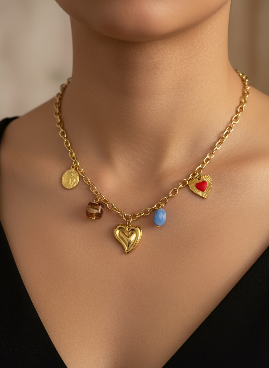 Gold necklace with heart-shaped charms on a black background