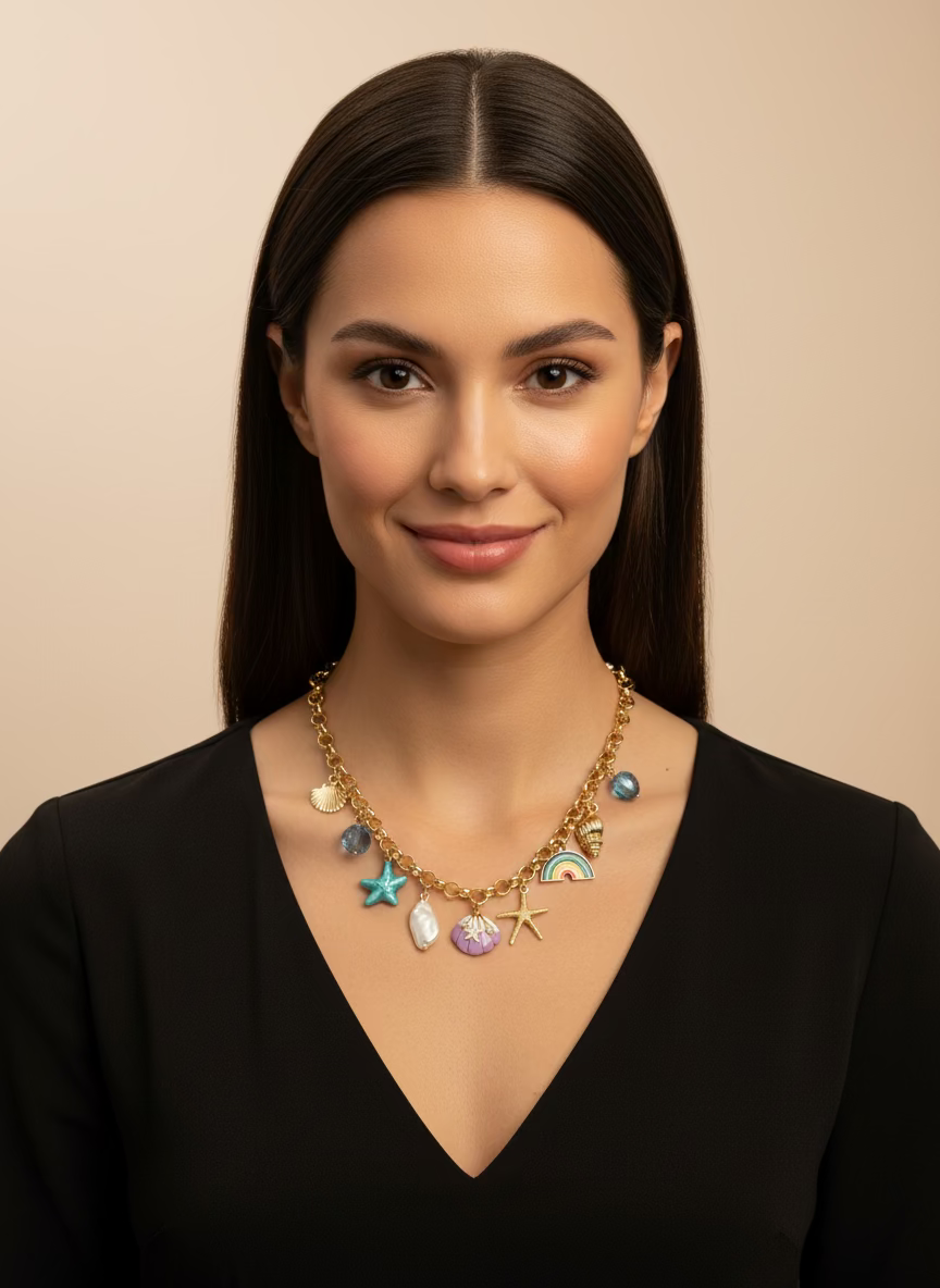 Necklace with various charms including a starfish, rainbow, and shells on a black background