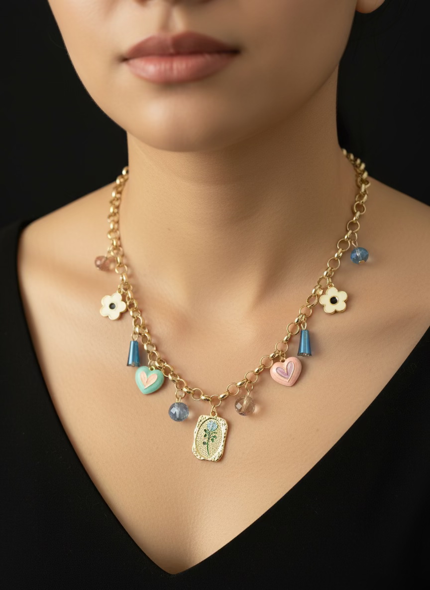 Gold necklace with various charms on a black background